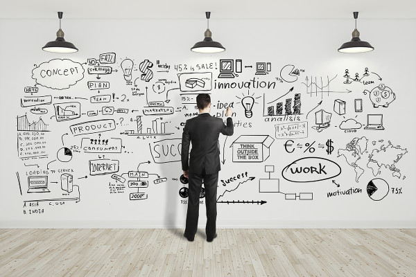 businssman drawing business concept on white wall